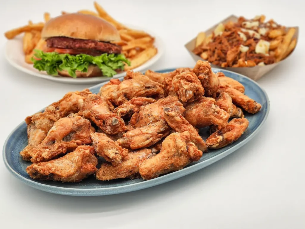 Chicken wings, burger and fries, poutine